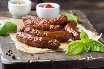 Grilled sausages with meat (beef, pork, lamb) and spices, hot merguez, kabanos, chorizo. Delicious fried food for picnic