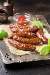 Grilled sausages with meat (beef, pork, lamb) and spices, hot merguez, kabanos, chorizo. Delicious fried food for picnic