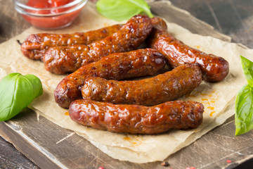 Grilled sausages with meat (beef, pork, lamb) and spices, hot merguez, kabanos, chorizo. Delicious fried food for picnic