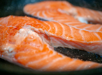 Raw salmon steak fillet macro shot on a frying pan. Food concept and dieting 