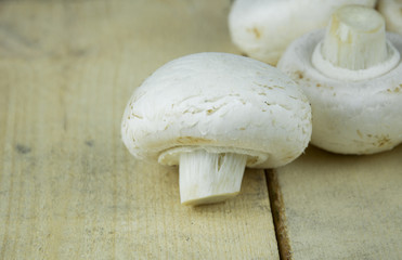 Champignon mushrooms on wooden background