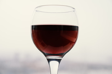 Wine in a glass on light background. Selective focus.