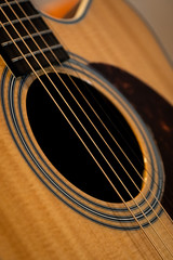 Obraz premium close up of an acoustic guitar playing classical play folk string band art hole object macro ukelele bass