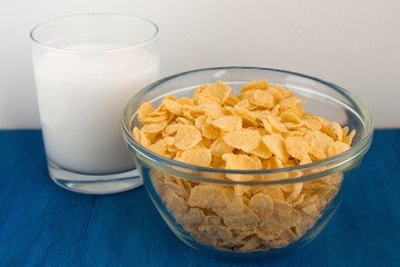  Cornflakes with milk for breakfast. Blue background.