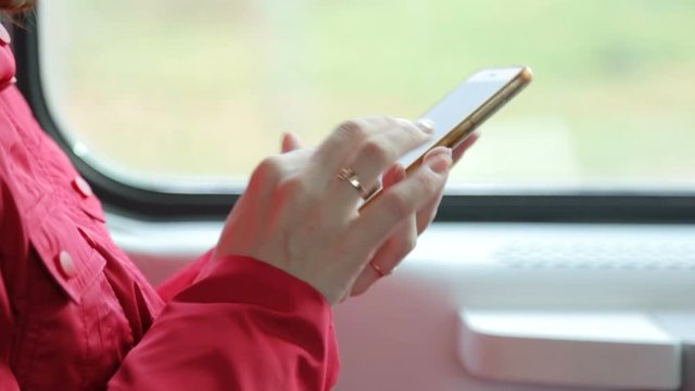 Woman with mobile phone in train