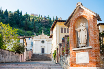 Fototapeta na wymiar view of classic old medieval italian capital with virgin mary statue in Marostica town in Veneto region at sunset with old church on the hills