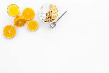 Healthy granola and orange juice for colorful breakfast on white background top view mock-up