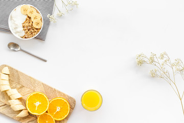 Healthy granola and orange juice for colorful breakfast on white background top view mock-up