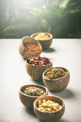 Assortment of dry tea in coconut bowls.