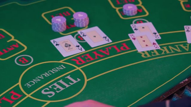 The hands of a croupier at the casino gaming table