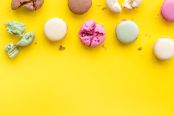 Macarons design on yellow background top view space for text