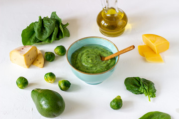 Cream soup with avocado, spinach and cheese. Healthy eating. White background
