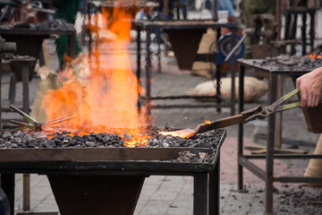 Blacksmiths coals. Blacksmith furnace with a hot iron. 