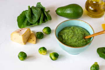 Cream soup with avocado, spinach and cheese. Healthy eating. White background
