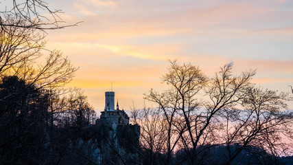 Fototapeta premium Germany, Lichtenstein castle in forest in magic glowing orange twilight