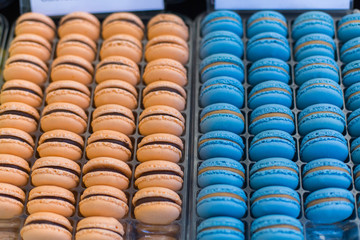 Colorful french macarons dessert with vintage pastel tones, close up. Tasty sweet color macaroon, bakery concept.