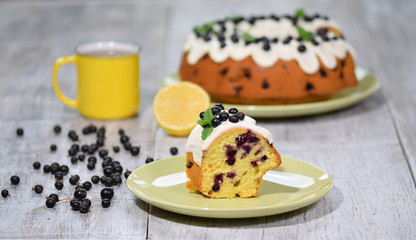 Piece of bundt cake with black currant and glaze