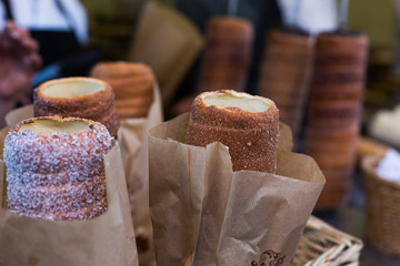 Trdelnik or Trdlo or Kurtosh Kalach being baked in a street bakery in Budapest