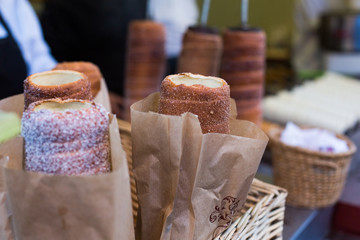 Trdelnik or Trdlo or Kurtosh Kalach being baked in a street bakery in Budapest