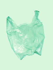 Obraz premium Light green plastic bag on green background.