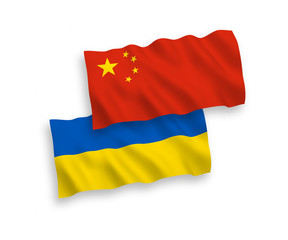 National vector fabric wave flags of Ukraine and China isolated on white background. 1 to 2 proportion.