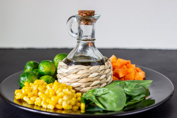 Plate with cabbage, carrots, corn and spinach. Healthy eating.