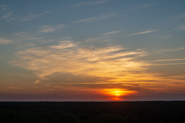 colorful sunset over the sea lake with dark red clouds