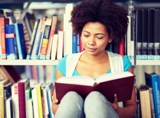 education, high school, university, learning and people concept - african american student girl...