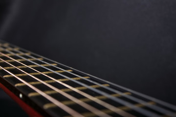 Fototapeta premium Fretboard and guitar strings on a gray background