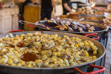 Young fried, whole village potatoes with onions in a large pan. Vending. Food Festival in Hungary