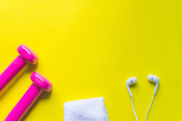 Fitness background, Equipment for gym and home dumbbell and Sneakers, earphone on color background. soft focus.