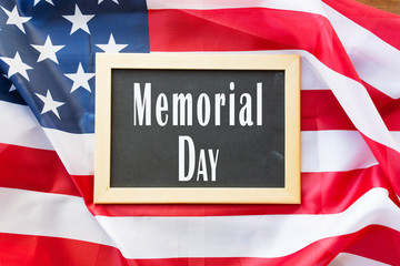 memorial day and patriotism concept - chalkboard on american flag