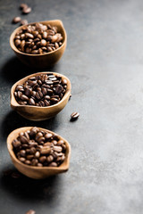 Three different varieties of coffee beans on dark vintage background