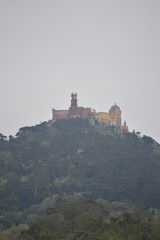 Wonderful Views Of The Palace Of Pena At The Top Of A Cliff On A Cloudy Day In Colares. Nature, architecture, history. April 14, 2014. Colares, Sintra, Lisbon, Portugal.