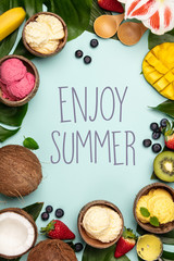 Tropical fruits and plants with variety of ice cream in coconut shells