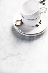 Fototapeta na wymiar Coffee composition on white marble background, copyspace