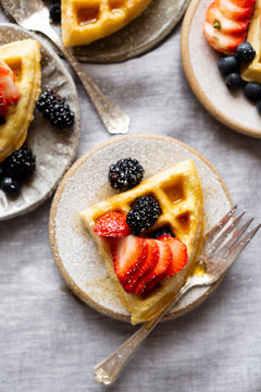 Gluten-free Paleo Waffle with Berries and Maple Syrup.