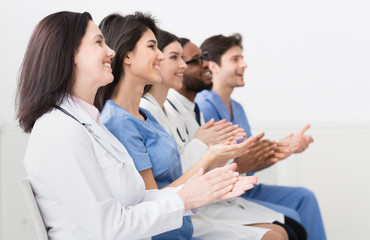 General Practitioners Applauding To Successful Lecturer In Room