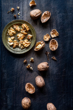 Walnuts over black wooden background