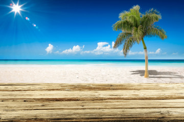 Desk of free space and summer background of ocean and beach with palm. Sunny day and blue sky. 