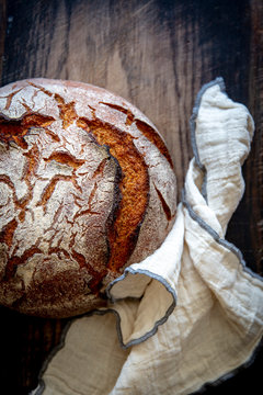 Artisan sourdough bread on wooden vintage board with blur