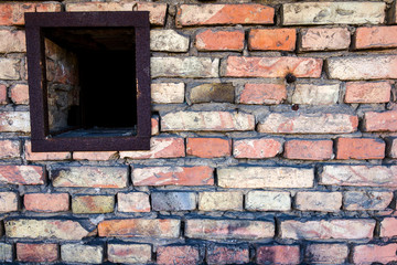 Old brick wall with a small window
