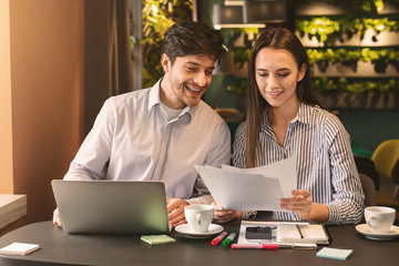 Millennial coworkers having business lunch at cafe