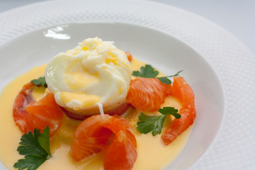 poached egg on fresh tomato and thinly sliced salmon