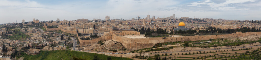 Fototapeta premium Beautiful panoramic aerial view of the Old City, Tomb of the Prophets and Dome of the Rock during a sunny and cloudy day. Taken in Jerusalem, Capital of Israel.