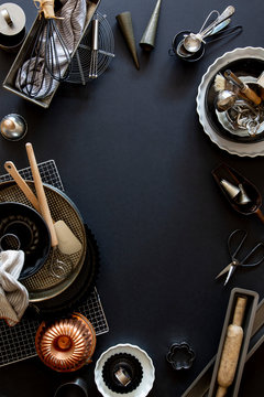 Baking and patisserie equipment over black background with copy space