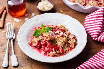 Crumble with berries and fruits. Wooden background.