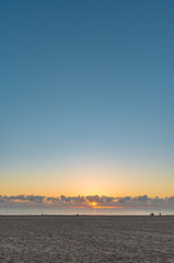 Fototapeta na wymiar clear blue sky over a white sandy beach at sunrise