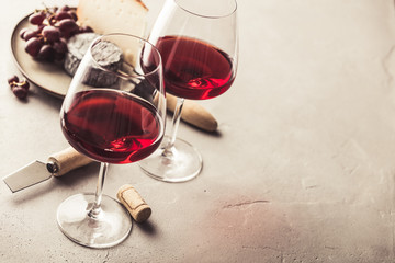 Red wine and cheese on concrete background, copyspace