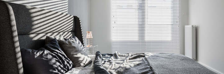 Gray bedroom with window blinds